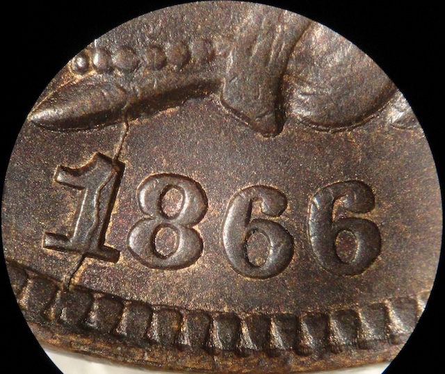1866 Indian Head penny die cud variety showing raised die break at coin rim